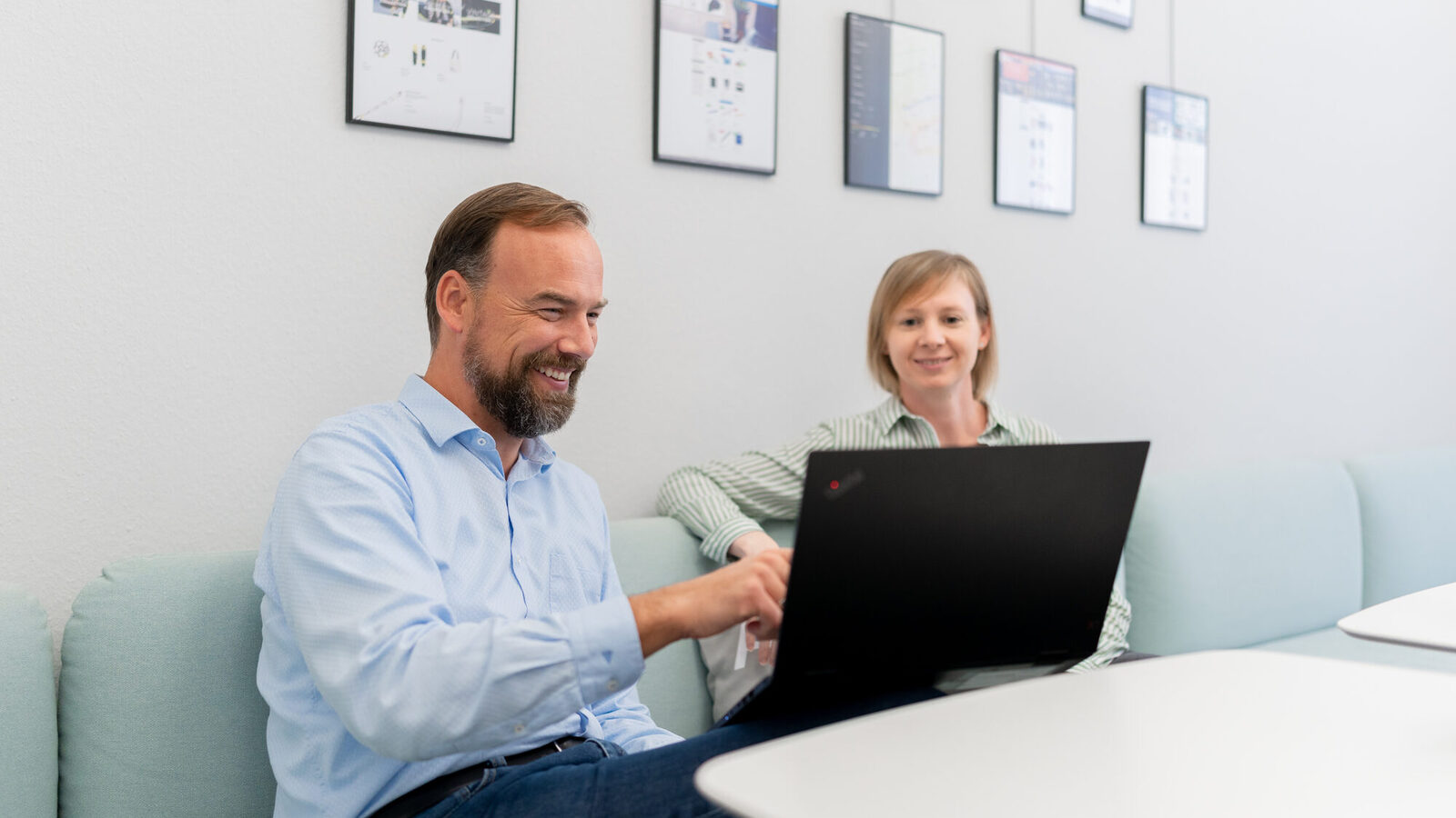 Man and woman sitting in front of a laptop